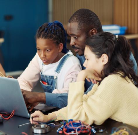 Science Teacher With Students at Laptop